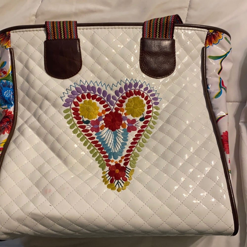 Small stain shown in picture. Natural wear on embroidery shown in picture.